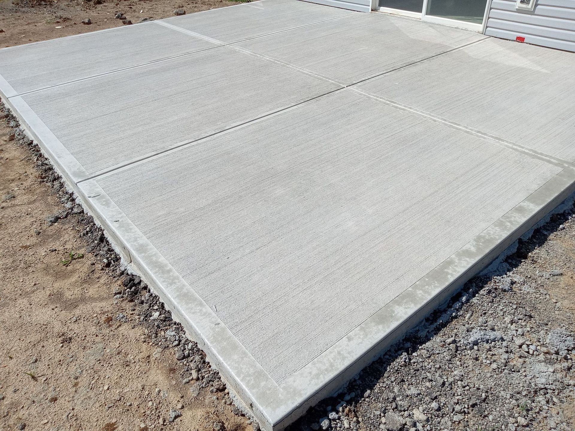 A newly installed concrete driveway in Tampa, FL, with precise control joints and a smooth finish. Perfect for those looking for ‘concrete driveway Tampa’ or ‘concrete contractors Tampa FL’ for long-lasting and durable solutions.